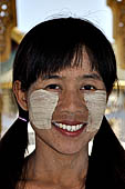 Myanmar - Mandalay, Kuthodaw Pagoda. Girl selling souvenirs wearing thanatkha   